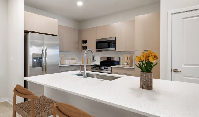 a kitchen with wood cabinets and stainless steel appliances
