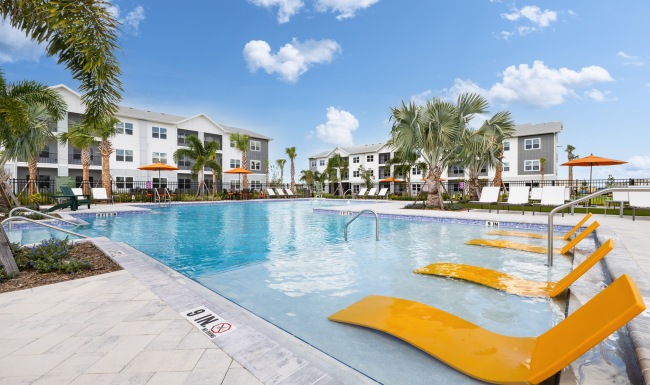 a swimming pool in front of a large building